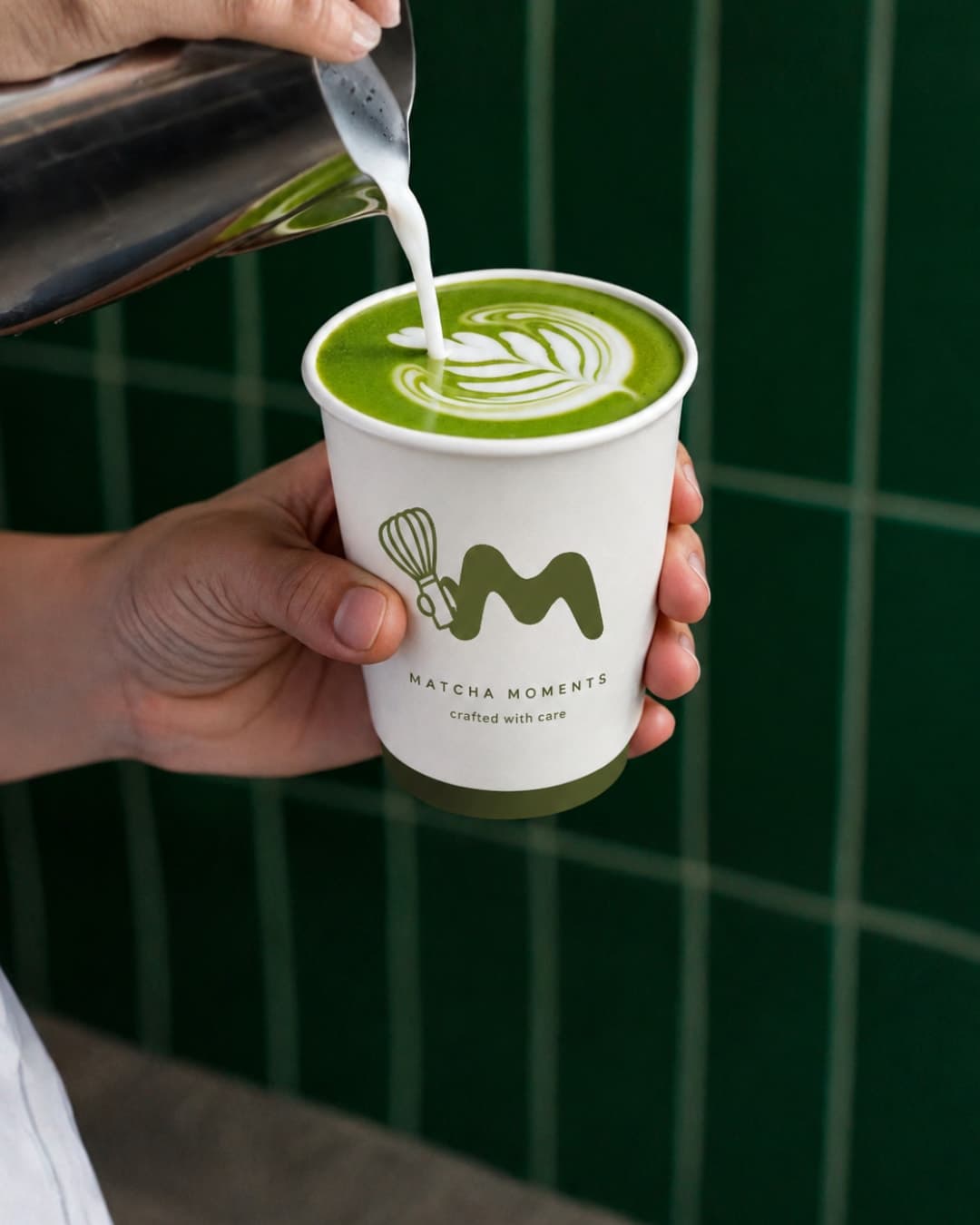Latte art being poured into a Matcha Cult cup