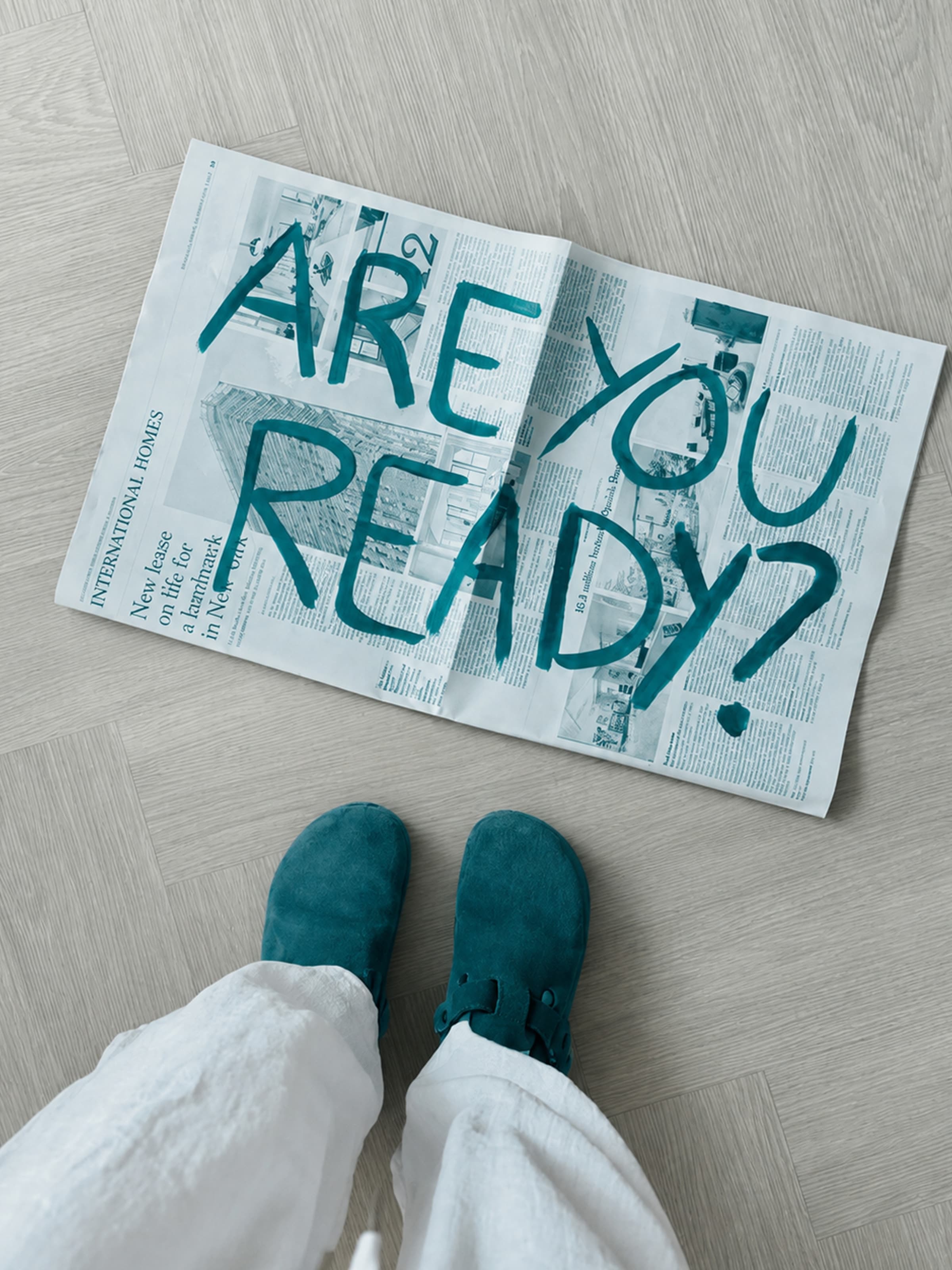 Are you ready? — a newspaper unfolded at someone's feet